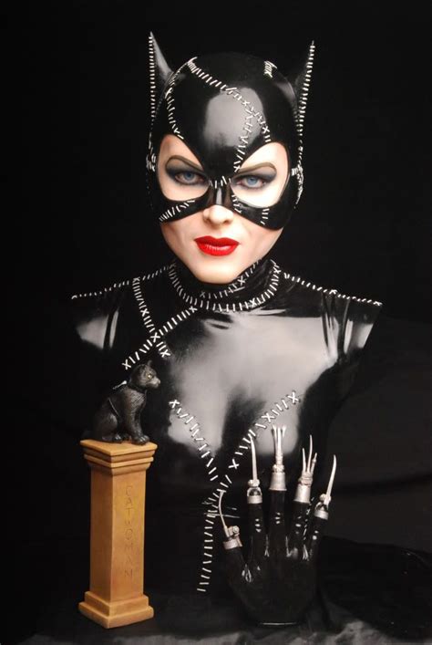 A Woman Dressed In Black Catwoman Costume With Her Hands On Top Of A Clock