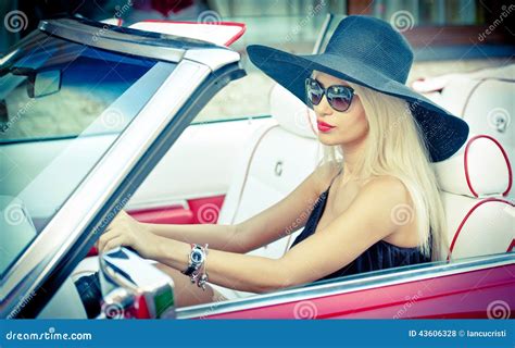 Outdoor Summer Portrait Of Stylish Blonde Vintage Woman Driving A Convertible Red Retro Car