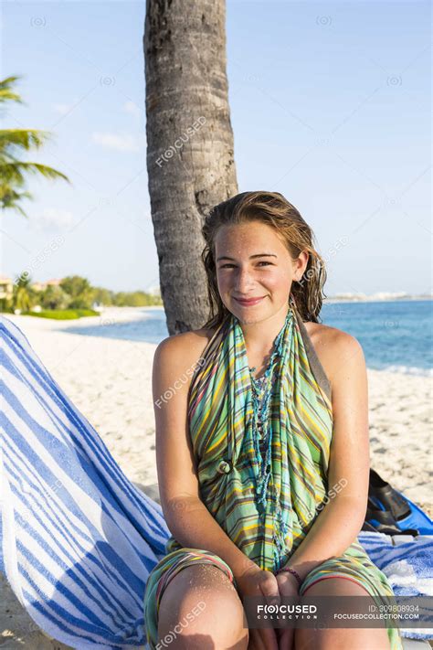 smiling teenage girl sitting in beach chair grand cayman island — relaxation water stock