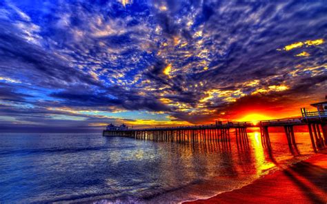 Sunset Beach Sea Pier Platform On Wooden Pillars Sky Clouds Evening