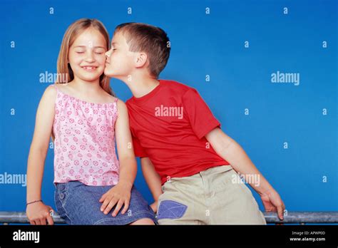 Boy Kissing Girl On The Cheek Stock Photo Alamy