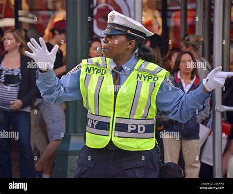 Female New York City Traffic Enforcement Officer Directing Cars At West