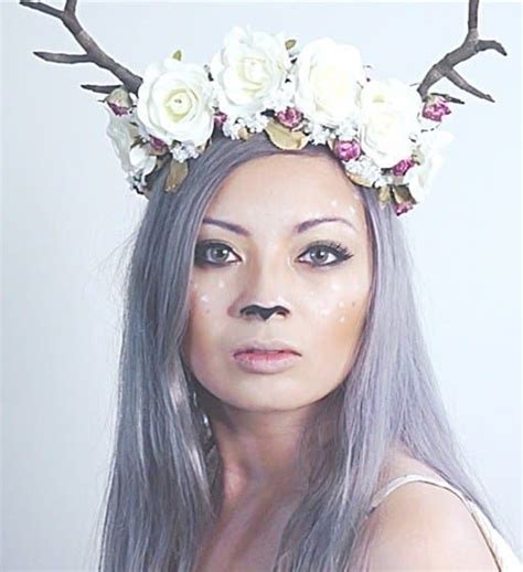 A Woman With Long Gray Hair Wearing A Deer Antlers Headpiece And