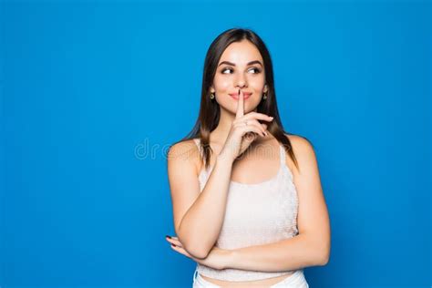 Pretty Charming Young Woman Having Secret While Holding Finger On Lips