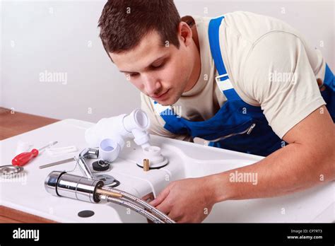 Plumbers Install Faucet Stock Photo Alamy