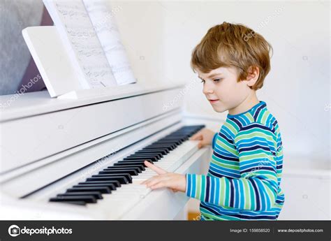 Beautiful Little Kid Boy Playing Piano In Living Room Or Music School
