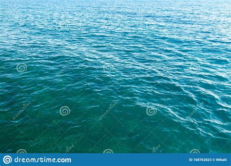 Clear Water Texture In Blue Background Of The Ocean And The Sea