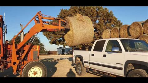 Loading And Unloading A Round Bale Of Hay In The Back Of A Truck Youtube