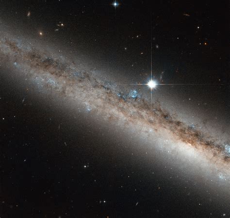 Hubble Views A Spiral Galaxy Crowned By A Star Nasa