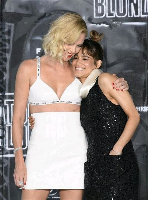 two women hugging each other in front of a black and white background with the words blond on it