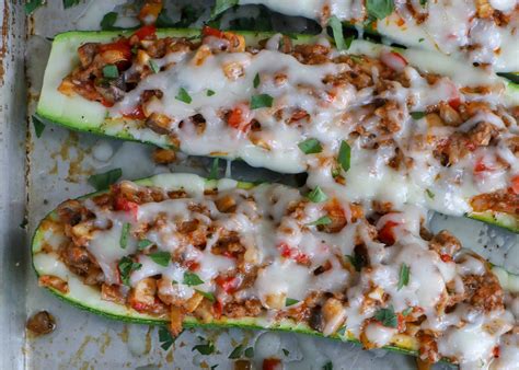 Spoon some pasta sauce into the baking sheet and spread all over. Cheesy Sausage Zucchini Boats | Barefeet In The Kitchen