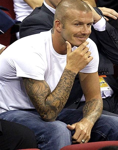 The back of the photo of david beckham visible tattoo with a cross with wings and the name of the second son of «romeo». cervecerix: Favorite Celebrity Tattoo Design - David Beckham