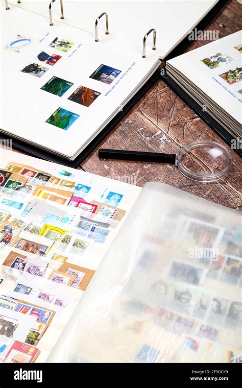 Stamp Albums Full Of Used British Postage Stamps Laid On A Rustic
