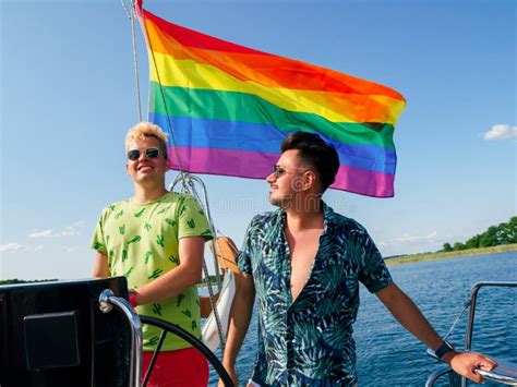 Gay Couple Have A Vacations On A Sailing Yacht With Lgbt Rainbow Flag
