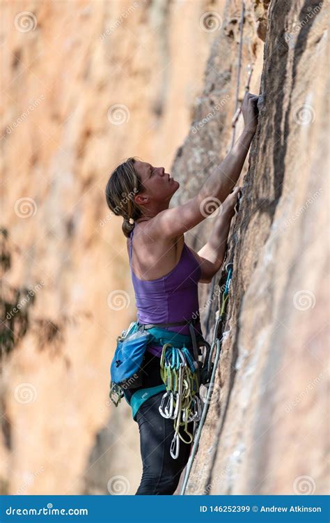 Woman Rock Climbs Vertical Cliff Face At Walls Ledge Porters Pass