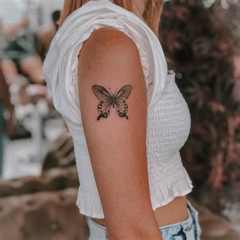 Tattoo Of A Butterfly Located On The Upper Arm