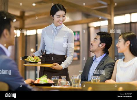 Chinese Waitress Serving In Restaurant Stock Photo Alamy