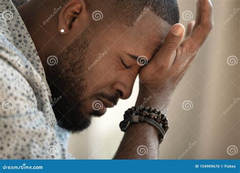 Upset Stressed Young African American Man Coping With Strong Headache