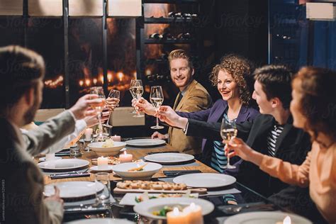 Group Of Business People Toasting At Dinner Party By Stocksy