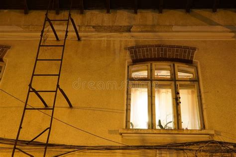 Old House Window Lit By Inside Light At Night In Bucharest Stock Image