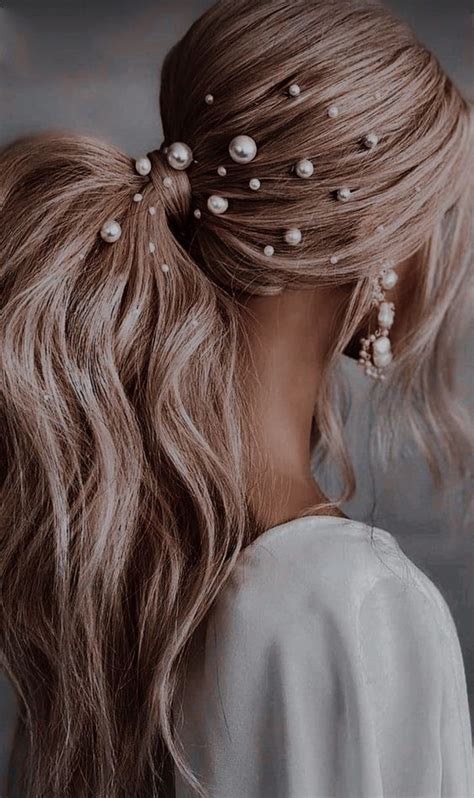 a woman with long hair and pearls in her hair