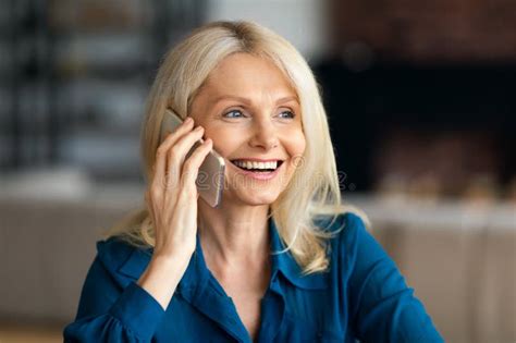 Positive Beautiful Mature Woman Having Pleasant Phone Conversation Sharing Good News Home