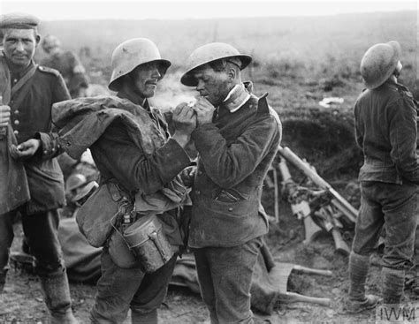 German Soldier Lights A Cigarette For A Wounded English Soldier After
