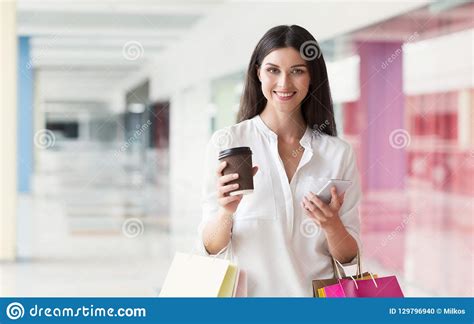 Happy Woman Using Smartphone While Shopping In Mall Stock Photo Image