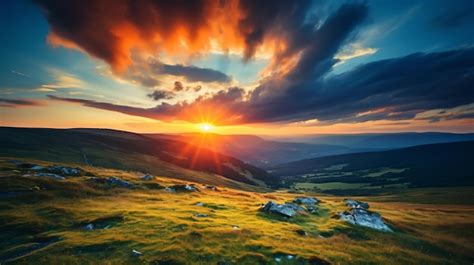 Premium Ai Image A Sunset Over A Grassy Hill With Rocks