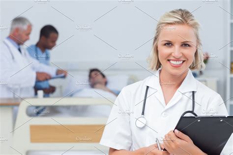Nurse Holding Clipboard And Looking At The Camera High Quality Stock