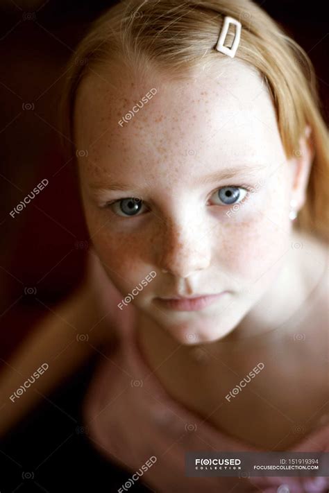 High Angle Portrait View Of Preteen Girl With Freckles Indoors