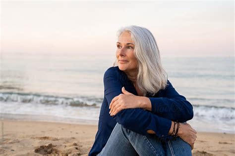 Beautiful Mature Woman Relaxing At Beach By Stocksy Contributor Alba Vitta Stocksy
