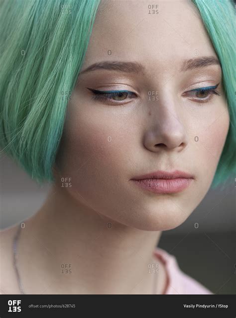Close Up Of Thoughtful Teenage Girl With Green Dyed Hair