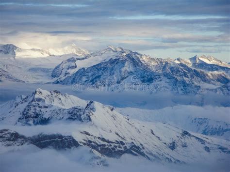 Amazing Aerial View Of Misty Swiss Alps And Clouds Above The Mountain