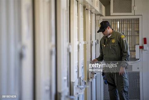 A Corrections Officer Checks A Cell At San Quentin State Prison In