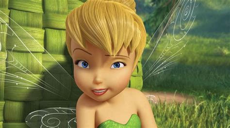 The Tinkerbell Fairy Is Sitting In Front Of Stacks Of Green Towels And