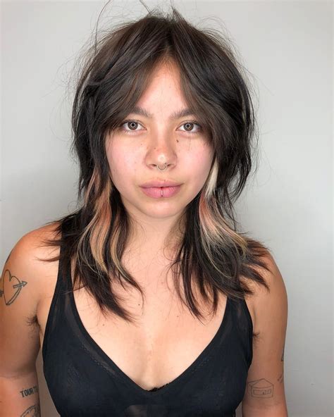 edgy brunette curtain banged shag with messy natural texture and pink and blonde peek a boo