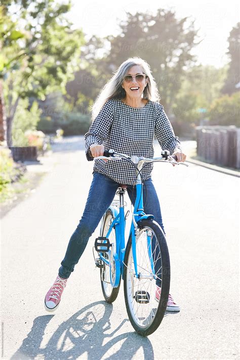 Portrait Of Stylish Mature Senior Woman Riding A Bike By Stocksy