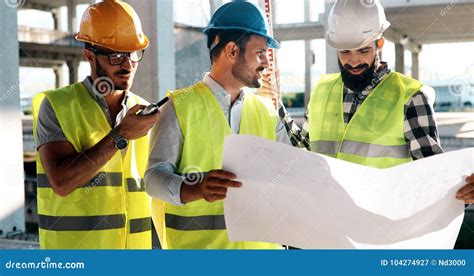 Team Of Construction Engineers Working On Building Site Stock Image