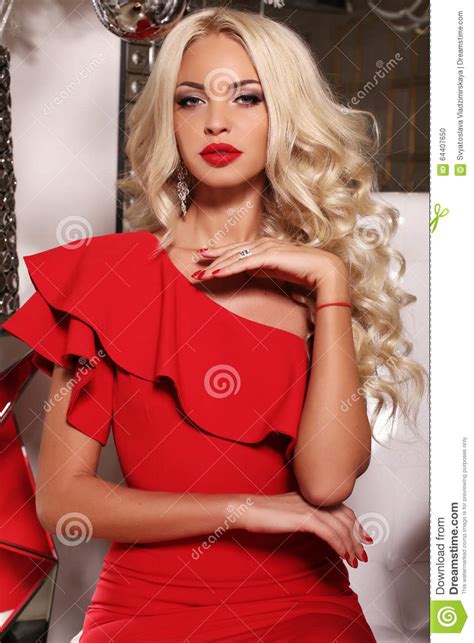 Gorgeous Woman With Long Blond Hair Wears Luxurious Red