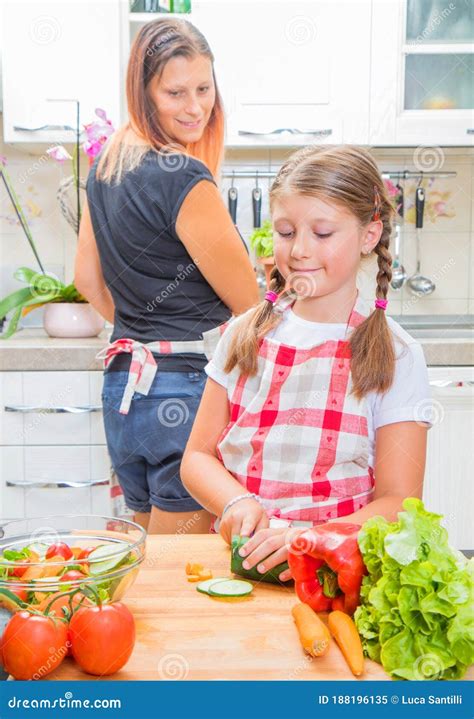 mother and daughter in kitchen are preparing vegetables stock image image of domestic life