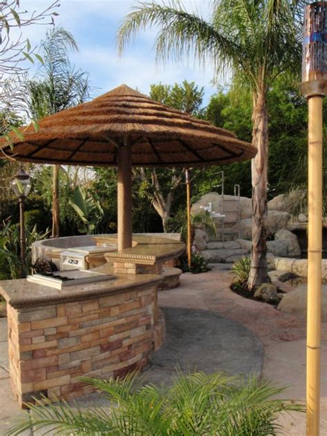 Rustic patio outdoor kitchen with bar is the best choice for those who like cozy look and simplicity. Tropical Style Outdoor Kitchen With Tiki Bar | HGTV