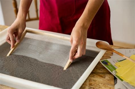 Free Photo Womans Hand Soaking Mold In Paper Pulp