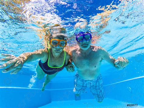 People Have Fun And Enjoy Swim Underwater In The Swimming Stock Photo