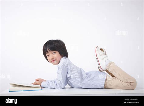 Boy Reading A Book Lying Down Hi Res Stock Photography And Images Alamy