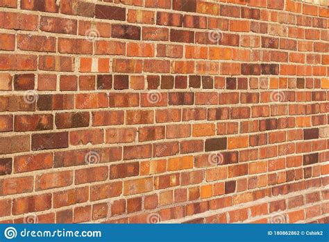 Older Red Clay Brick Wall Background With Grungy Texture Stock Photo