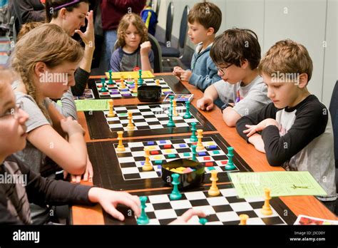 Caucasian American School Children Playing Game Of The Amazons Board