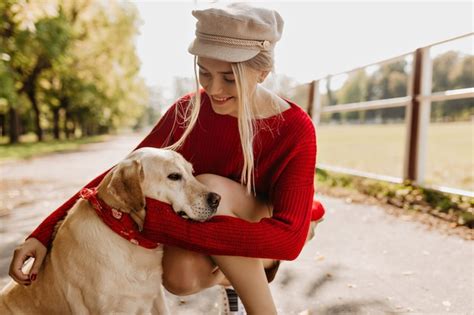 Free Photo Happy Woman Holding Her Dog Tenderly In The Autumn Park