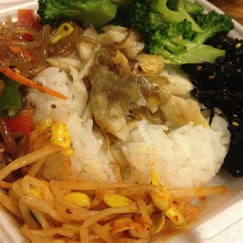 A White Plate Topped With Rice And Veggies