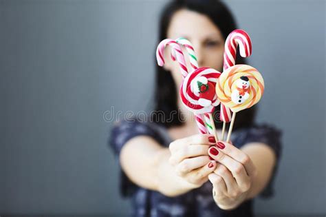 The Girl Holds Colored Christmas Candies In Her Hands Sweets In The